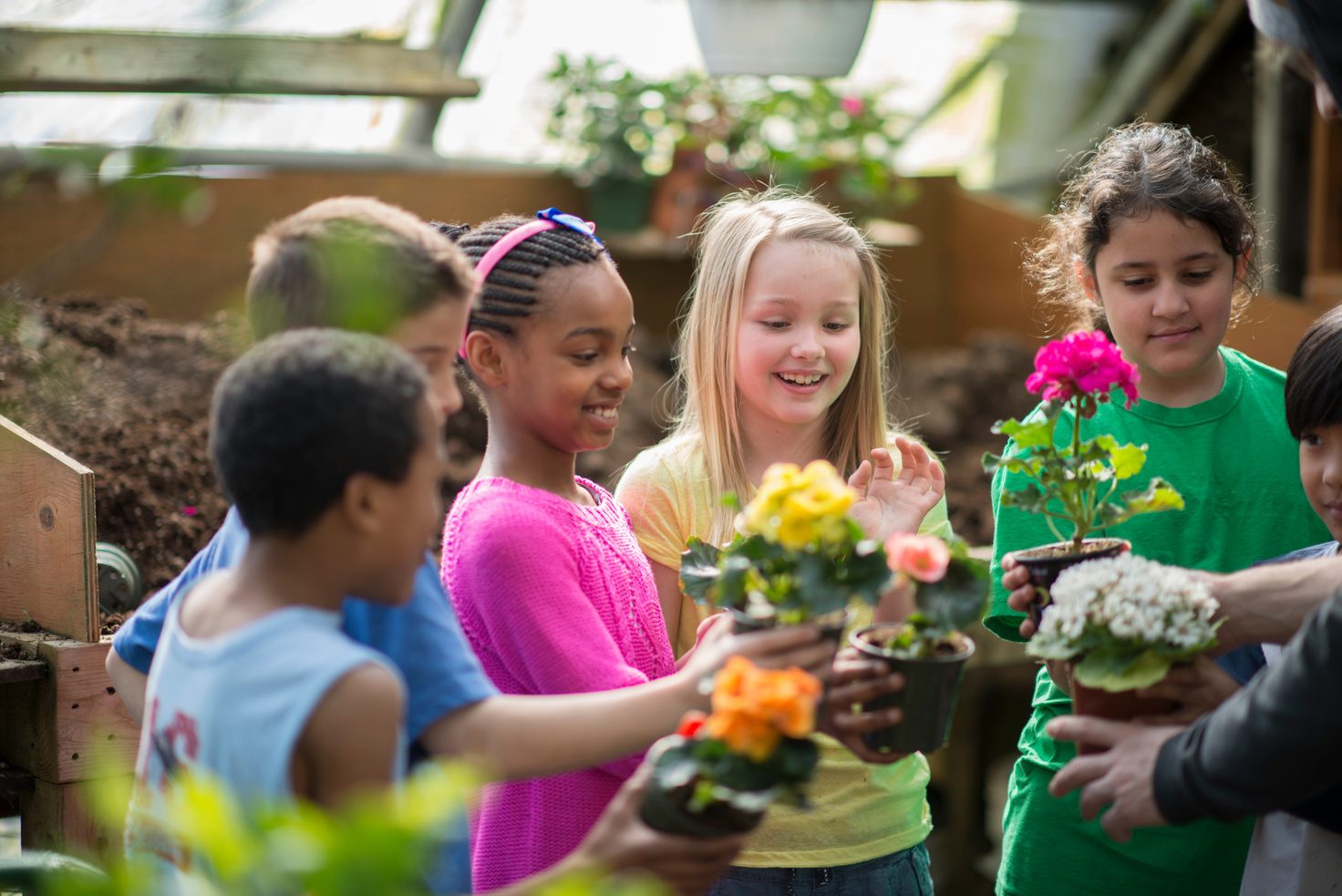 Children learning about plants in a greenhouse